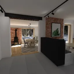 Wnętrze domu: widok z szarej podłogi na salon z ceglaną ścianą, kominkiem, drewnianym stołem i krzesłami, oraz na kuchnię z drewnianymi szafkami i czarnym blatem.