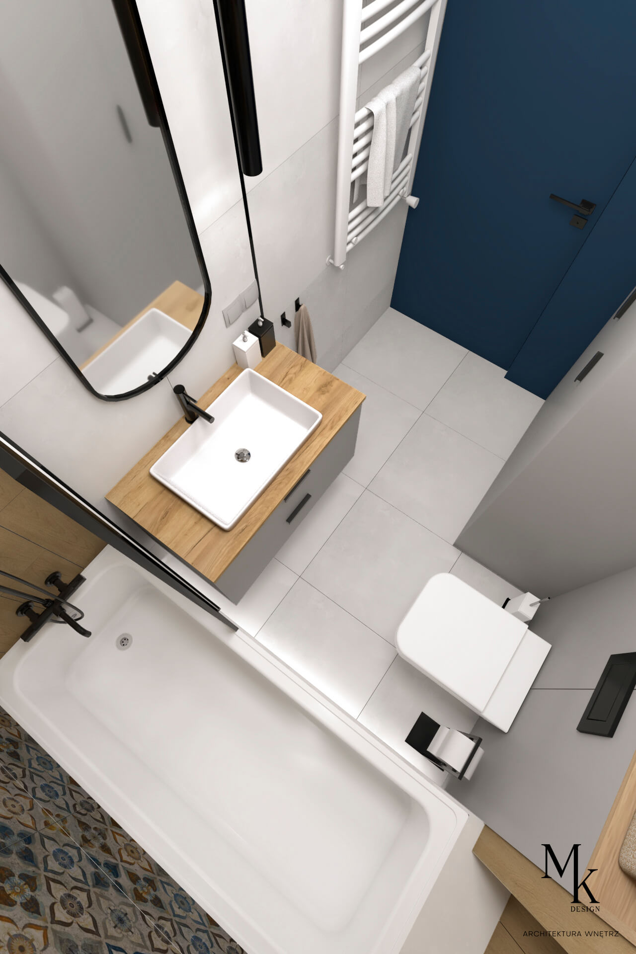 Wnętrze łazienki z perspektywy z góry: biała wanna z czarną armaturą, umywalka nablatowa na drewnianym blacie, toaleta i niebieskie drzwi. Na podłodze wzorzyste płytki przy wannie.
