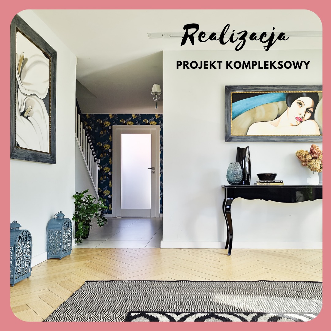 Jasny przedpokój z parkietem w jodełkę, czarnym dywanem w geometryczne wzory, konsolą z dekoracjami, obrazami w szarych ramach i dekoracyjnymi lampionami, widok na schody z tapetą w liście.