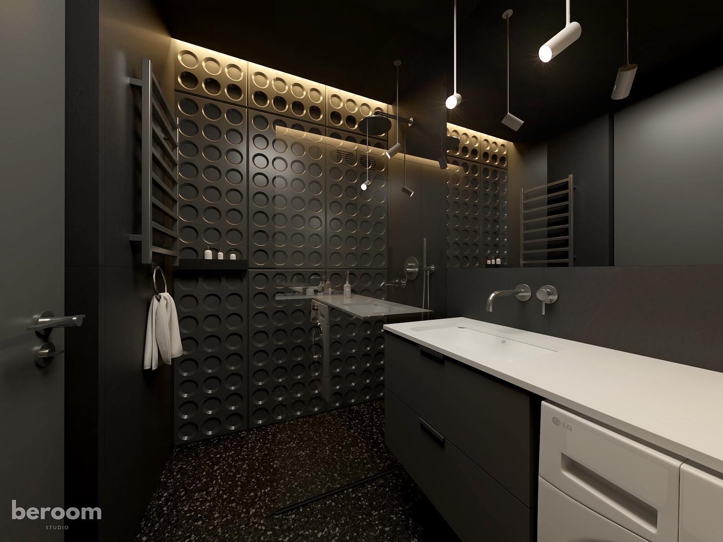 Nowoczesna łazienka w odcieniach szarości i czerni z dekoracyjną ścianą z okrągłymi wgłębieniami, podświetleniem LED, wiszącymi lampami punktowymi i blatem z wbudowaną umywalką.