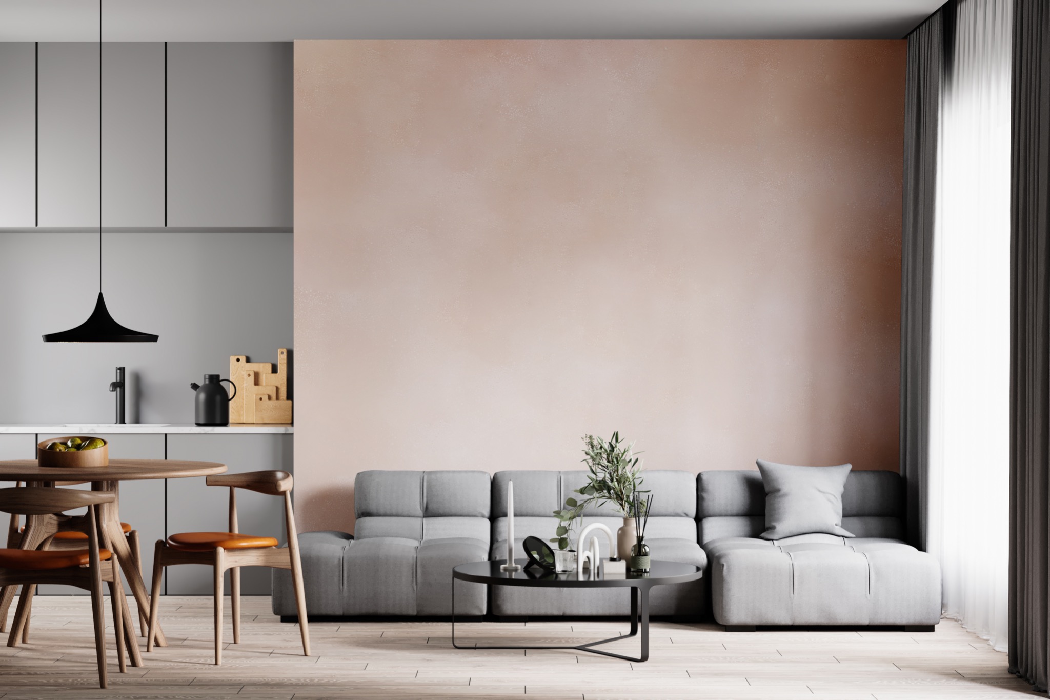 Wnętrze mieszkania z szarą zabudową kuchenną, drewnianym stołem z owocami, szarą sofą i okrągłym stolikiem kawowym na parkiecie.