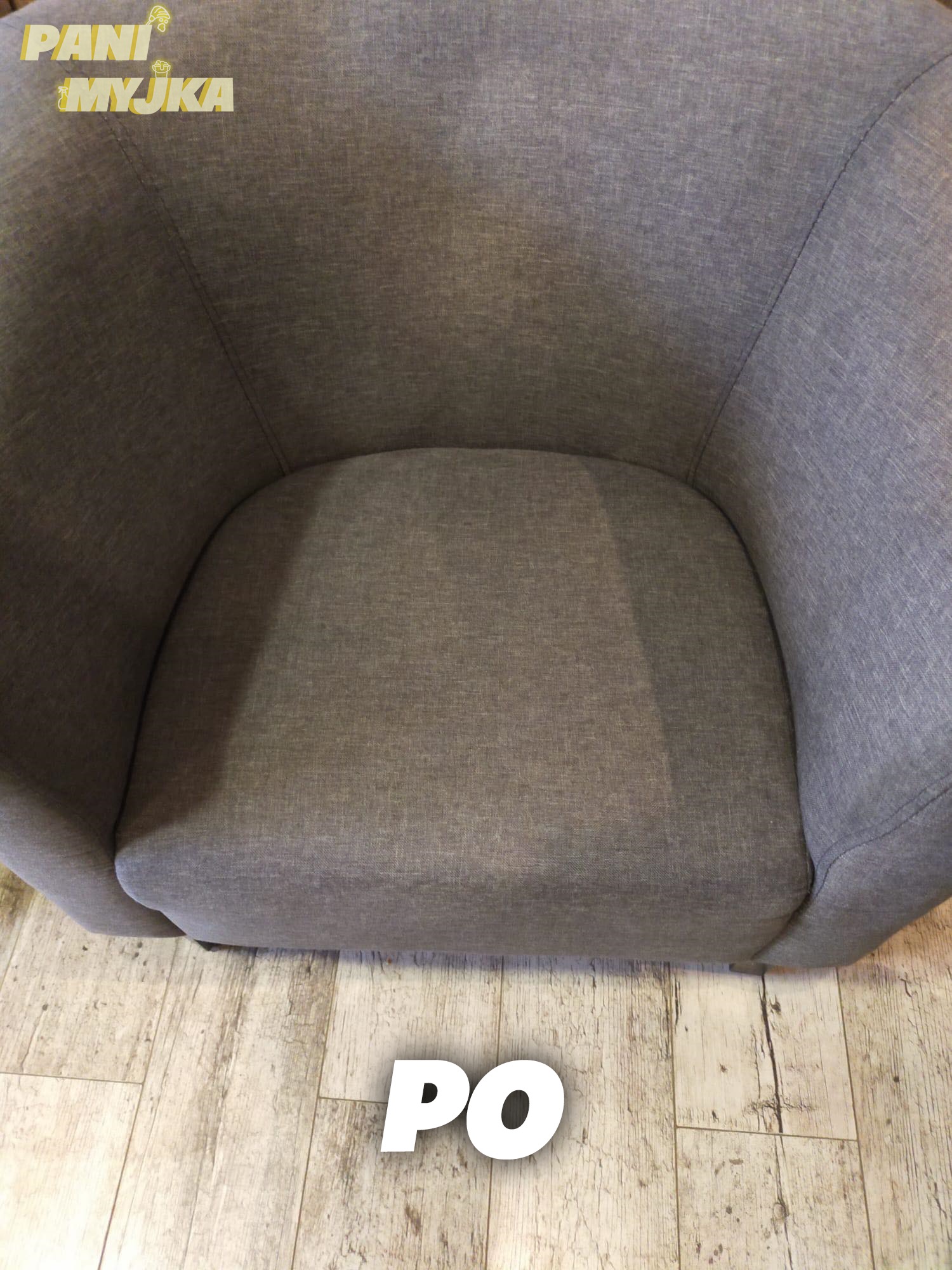 Szary fotel tapicerowany po czyszczeniu, widoczne jaśniejsze plamy po usuniętych zabrudzeniach, na podłodze panele imitujące drewno.