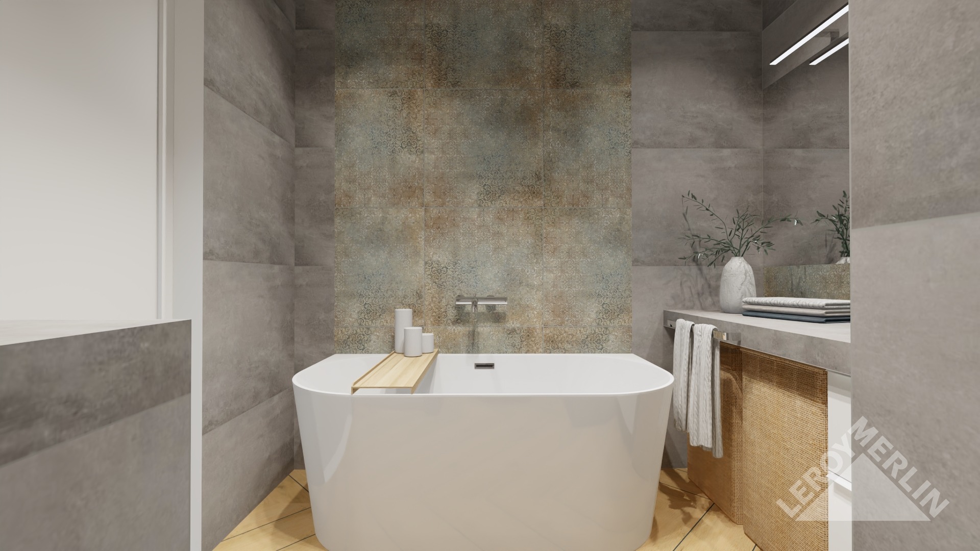 Nowoczesna łazienka z wolnostojącą białą wanną, drewnianą półką, szarą płytką imitującą beton oraz dekoracyjną ścianą z płytek w odcieniach brązu i zieleni, uzupełniona o minimalistyczną armaturę...