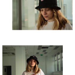 Julita Franek - Portret młodej kobiety w czarnym kapeluszu typu bucket hat i białym T-shircie z logo Dickies, stojącej w minimalistycznym, jasnym wnętrzu z widoczną przestrzenią biurową