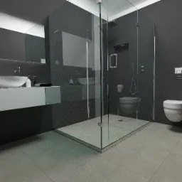 Nowoczesna łazienka w odcieniach szarości z kabiną prysznicową typu walk-in, wiszącą toaletą i umywalką nablatową na szafce. Widoczny minimalistyczny design i duże, ciemne płytki na ścianach.