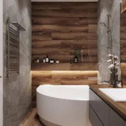 Nowoczesna łazienka z drewnianymi panelami ściennymi i podłogą, okrągła biała wanna, szare płytki na ścianach, podświetlana półka z kosmetykami i minimalistyczna umywalka z drewnianym blatem.
