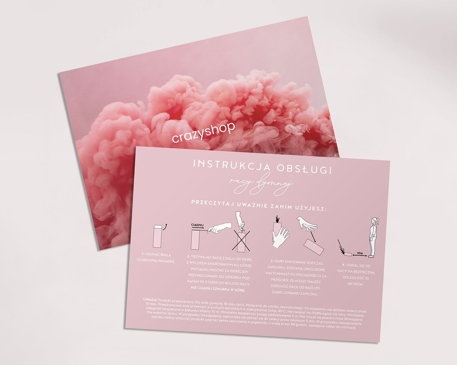 Różowa ulotka z instrukcją obsługi racy dymnej, leżąca na tle z efektem różowego dymu, widoczne schematy użycia racy.