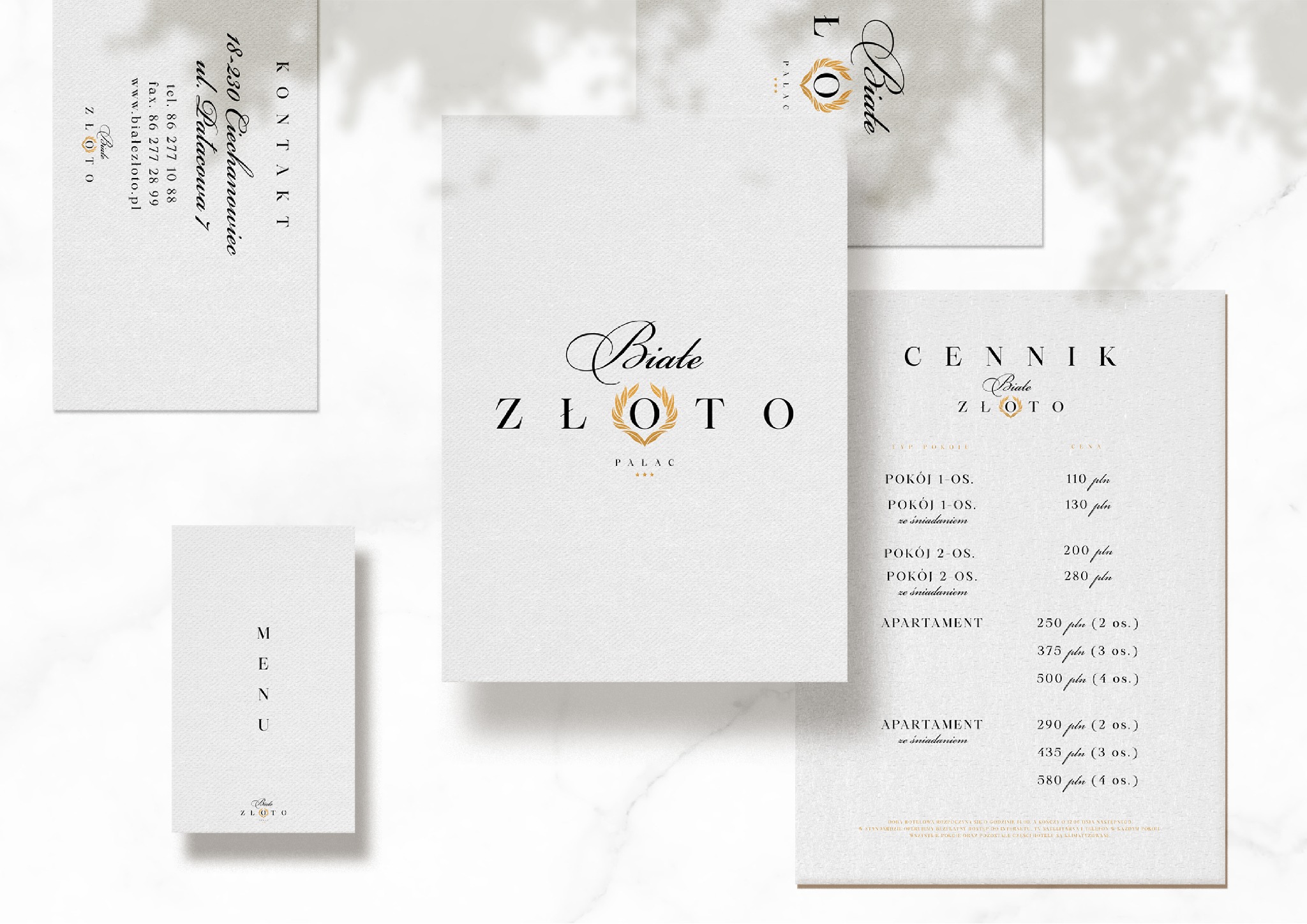 Zestaw materiałów identyfikacyjnych dla hotelu 'Białe Złoto' prezentujący logo, wizytówkę, menu i cennik w minimalistycznym stylu z użyciem czcionki szeryfowej i złotej kolorystyki.