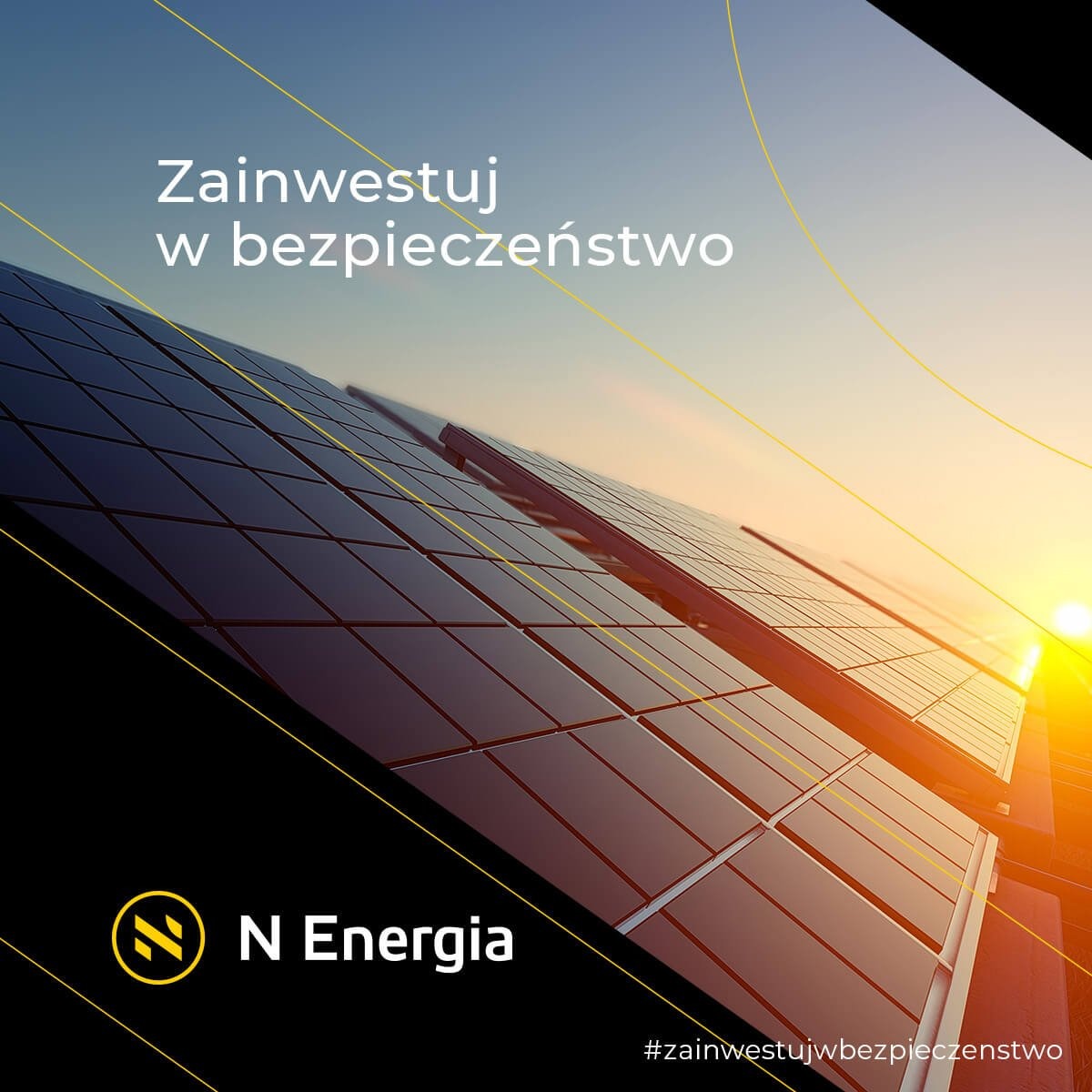 Panel fotowoltaiczny o zmierzchu, z logo N Energia w lewym dolnym rogu i hasłem 'Zainwestuj w bezpieczeństwo' u góry, z hashtagiem #zainwestujwbezpieczenstwo.