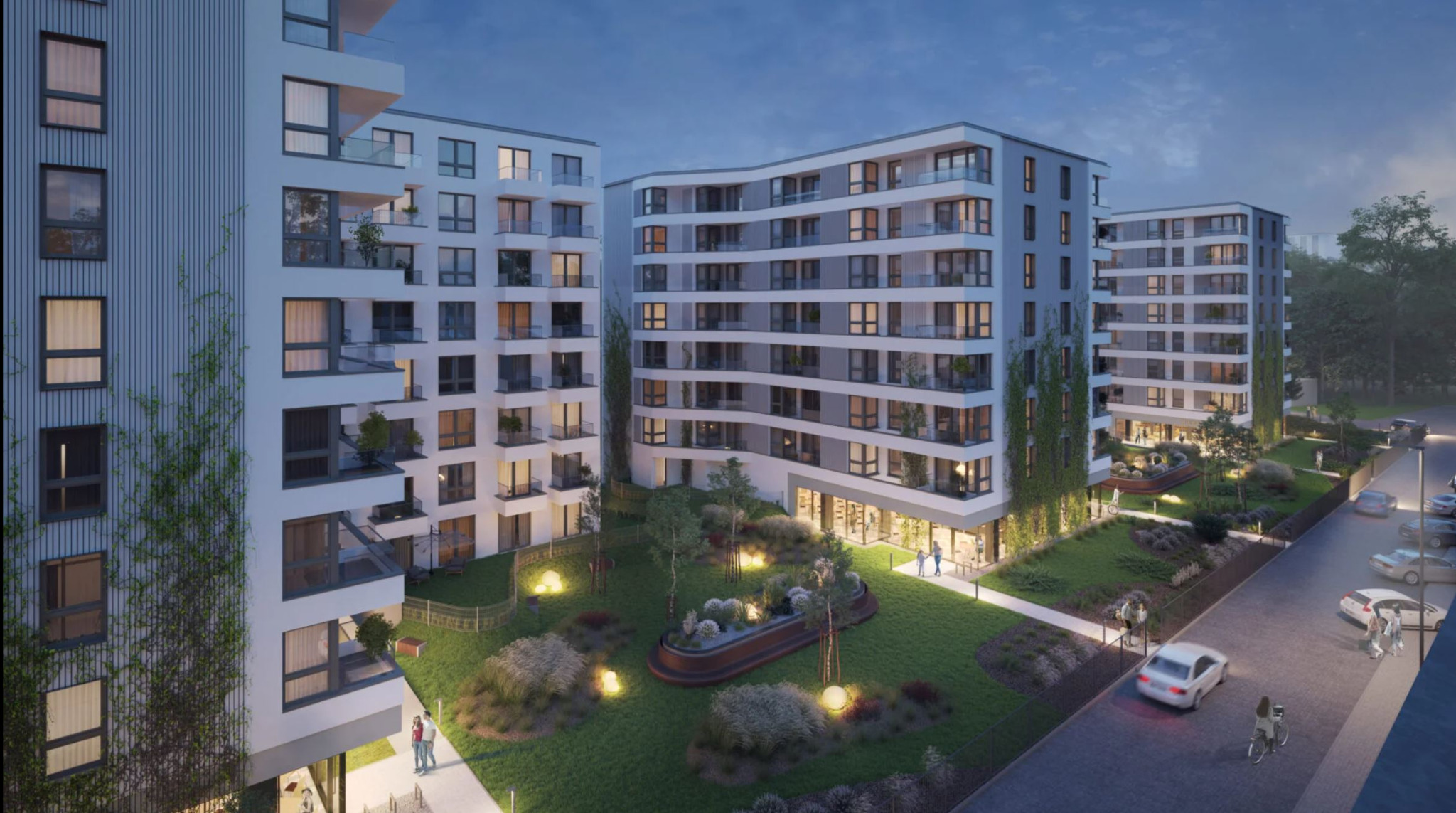 Nowoczesne apartamentowce z balkonami, oświetlony teren zielony z roślinami, wieczorny widok z perspektywy ulicy, przechodnie i samochody.