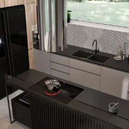 Nowoczesna kuchnia z czarnym sprzętem AGD i wyspą kuchenną z płytą indukcyjną, nad którą unosi się para z gotującego się garnka.