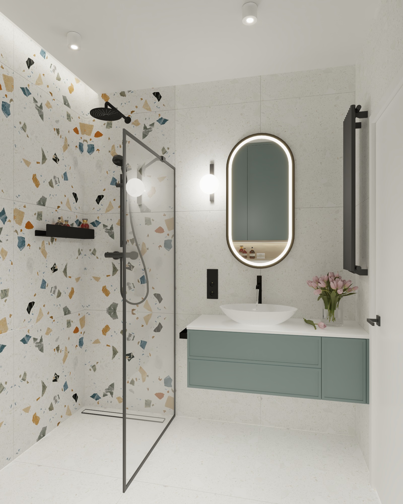 Nowoczesna łazienka z kabiną prysznicową typu walk-in, umywalką nablatową na szafce w kolorze pastelowej zieleni, okrągłym lustrem z podświetleniem LED i ścianą wyłożoną płytkami imitującymi lastryko.