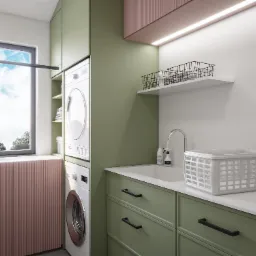 Nowoczesna pralnia z zielonymi szafkami, pralką i suszarką w kolumnie, białym zlewem i koszem na pranie na blacie.