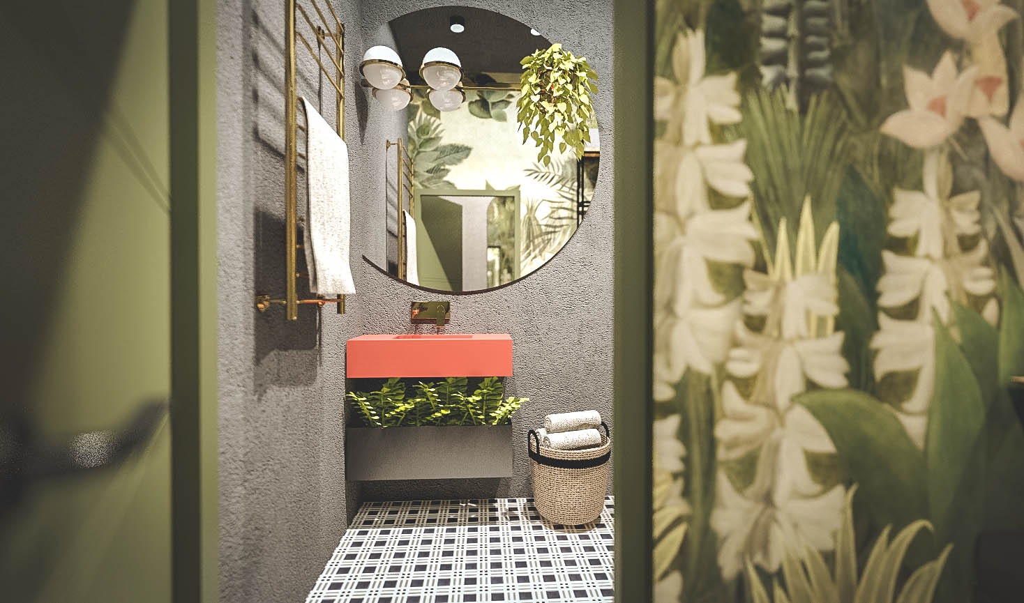 Nowoczesna łazienka z umywalką w kolorze koralowym, roślinnością pod nią i okrągłym lustrem z tropikalną tapetą odbijającą się w tle, widoczny grzejnik drabinkowy i kosz na ręczniki.