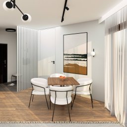 Coren Studio Design - Jasna jadalnia z drewnianym stołem, białymi krzesłami i abstrakcyjnym obrazem. Minimalistyczny design z elementami dekoracyjnymi i naturalnym światłem.