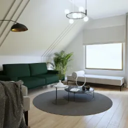 Jasne poddasze z zieloną sofą, okrągłym dywanem i nowoczesnym oświetleniem, akcentowane rośliną doniczkową i tekstyliami w stonowanych barwach.