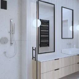 Nowoczesna łazienka z kabiną prysznicową, szafką z umywalką nablatową, dwoma lustrami w czarnych ramach i wiszącą lampą kulą, z widocznym grzejnikiem drabinkowym w odbiciu lustra.