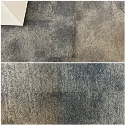 MajLen - Dywan w odcieniach szarości, podzielony na czystą i zabrudzoną część. Widoczny fragment białego mebla w lewym górnym rogu. Ukazuje efekt po praniu.