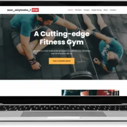 Laptop wyświetlający stronę internetową siłowni z dwoma mężczyznami ćwiczącymi na tle, hasłem 'A Cutting-edge Fitness Gym' i przyciskiem 'Find a Training Group'.