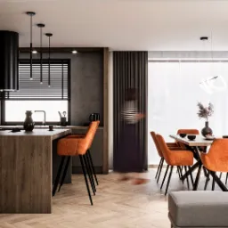 Nowoczesna kuchnia z wyspą i pomarańczowymi hokerami, parkiet w jodełkę, minimalistyczne oświetlenie, dekoracje stołu. Stonowana kolorystyka, elegancki design.