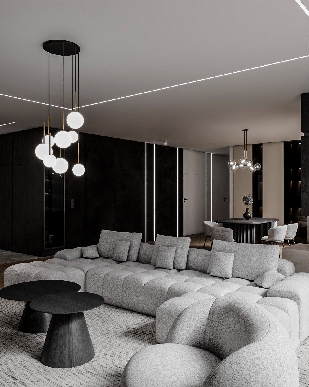 Nowoczesny salon z szarą sofą modułową, okrągłymi stolikami i designerską lampą wiszącą z kulistymi kloszami. Minimalistyczne oświetlenie liniowe sufitu.