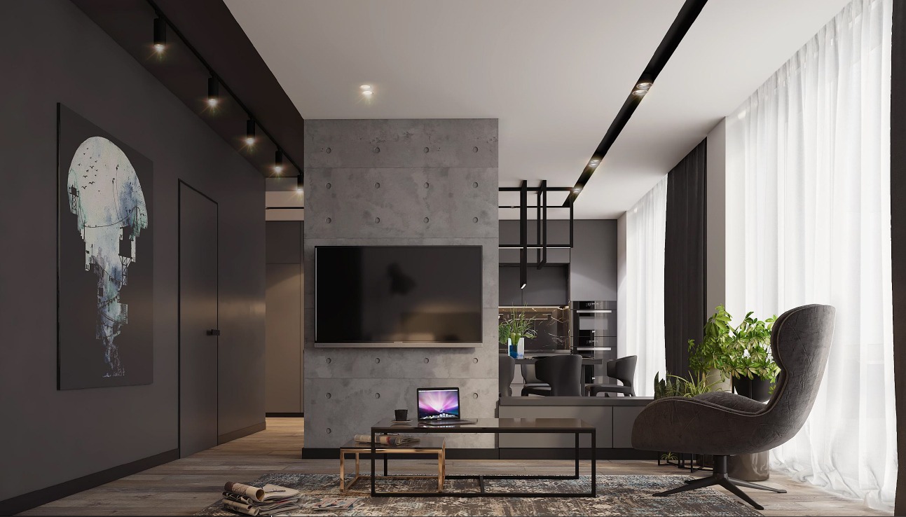 Nowoczesny salon z betonową ścianą, telewizorem, laptopem na stoliku kawowym i designerskim fotelem obok okna z białymi zasłonami, oświetlenie punktowe, minimalistyczny wystrój.