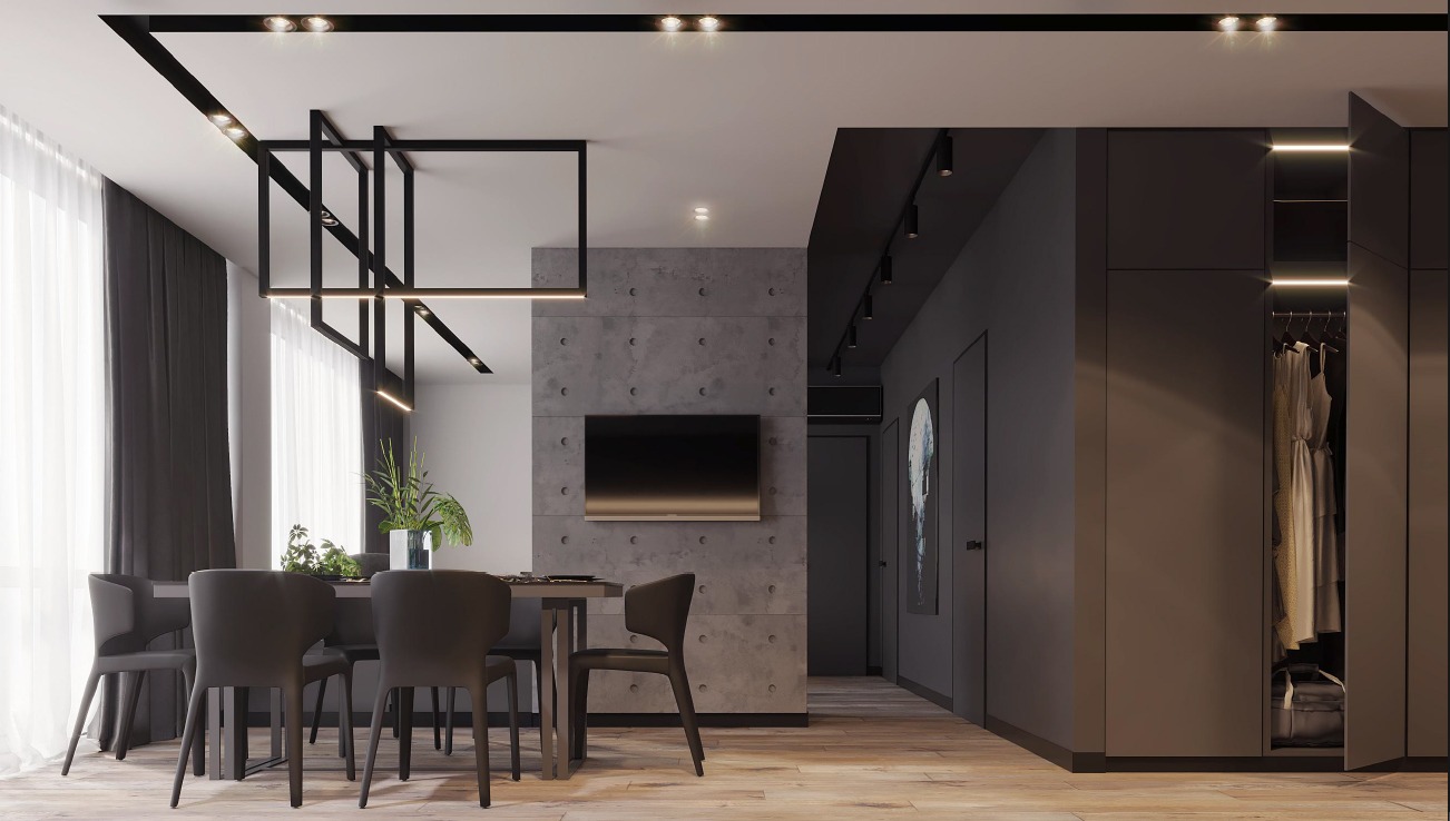 Nowoczesne wnętrze mieszkania z betonową ścianą, minimalistycznym oświetleniem i szarymi meblami, widok na jadalnię i otwartą szafę.