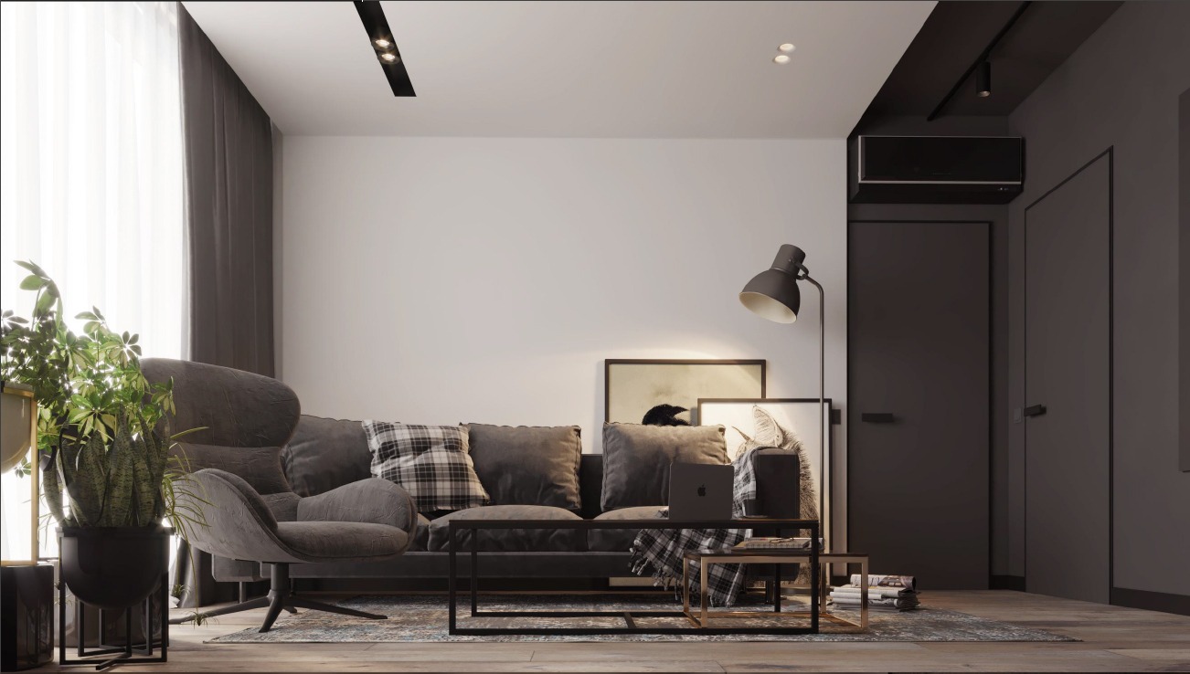 Nowoczesny salon w stonowanej kolorystyce z szarym narożnikiem, fotelem obrotowym, stolikiem kawowym z laptopem, lampą podłogową i rośliną doniczkową w geometrycznej donicy.