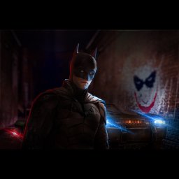 Mateusz Działak - Mroczny portret Batmana w kostiumie, z graffiti Jokera na ceglanej ścianie w tle i Batmobilem z włączonymi światłami, w ciemnym zaułku.
