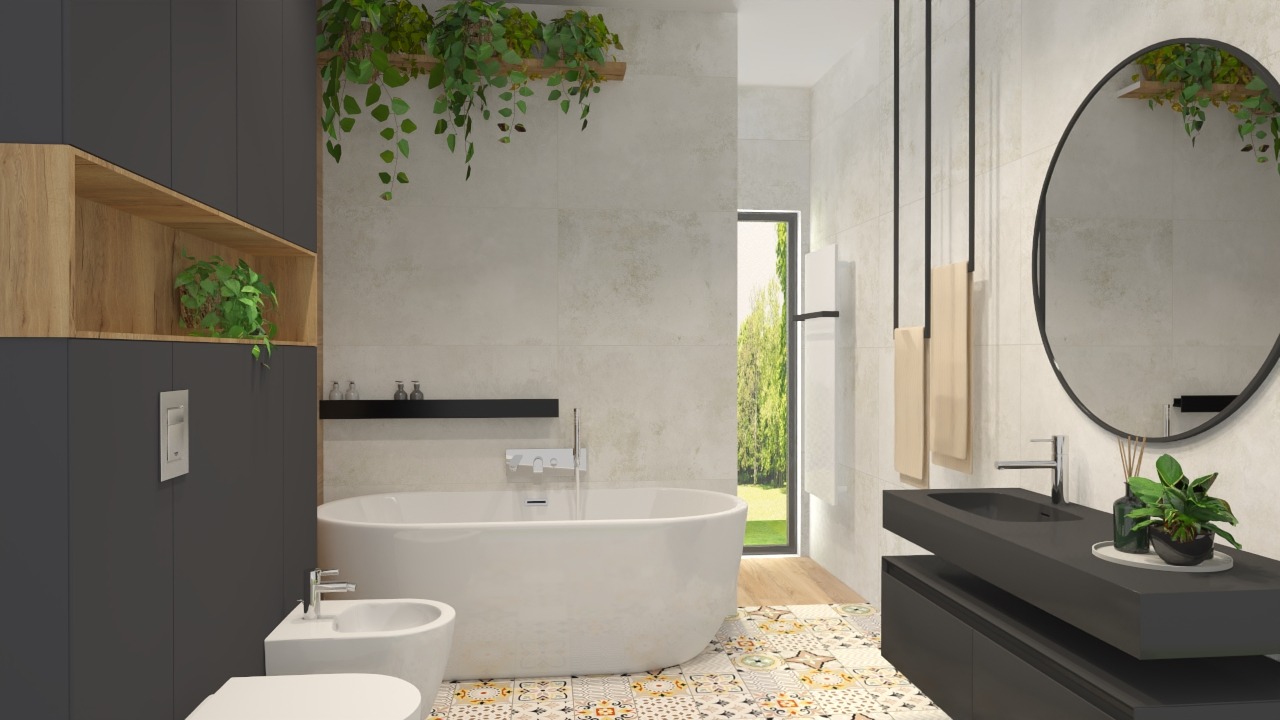 Nowoczesna łazienka z wolnostojącą wanną, bidetem i umywalką na szafce w kolorze grafitu, z okrągłym lustrem i dekoracyjnymi płytkami podłogowymi, oświetlona naturalnym światłem wpadającym przez okno.