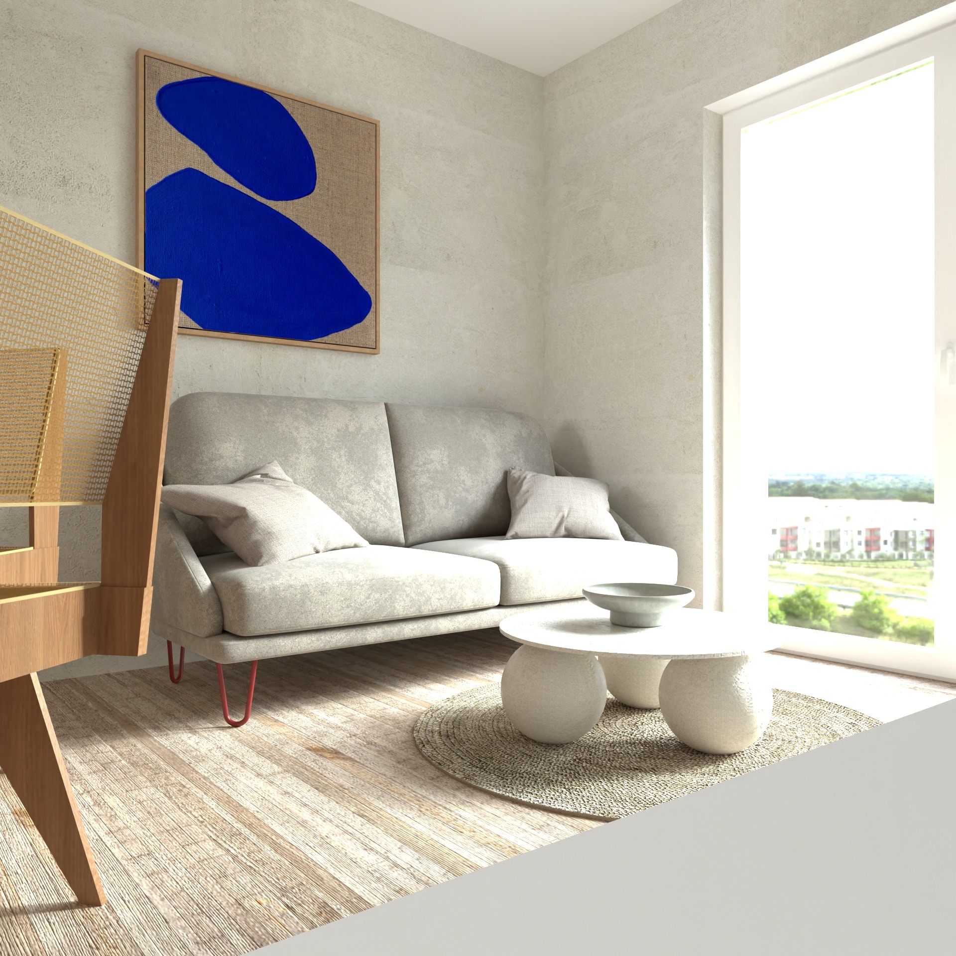 Jasny salon z szarą sofą na czerwonych nóżkach, okrągłym stolikiem kawowym z trzema okrągłymi nogami, drewnianą podłogą i abstrakcyjnym obrazem w niebieskich odcieniach.