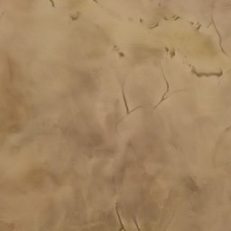 A.L. Andrii Chylin - Beżowa ściana z nieregularną teksturą, imitująca naturalny kamień z delikatnymi żyłkami i subtelnymi przejściami tonalnymi.