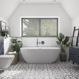 Nowoczesna łazienka na poddaszu z wolnostojącą wanną, umywalką nablatową, podwieszaną toaletą, wzorzystą podłogą i roślinami doniczkowymi przy oknie.