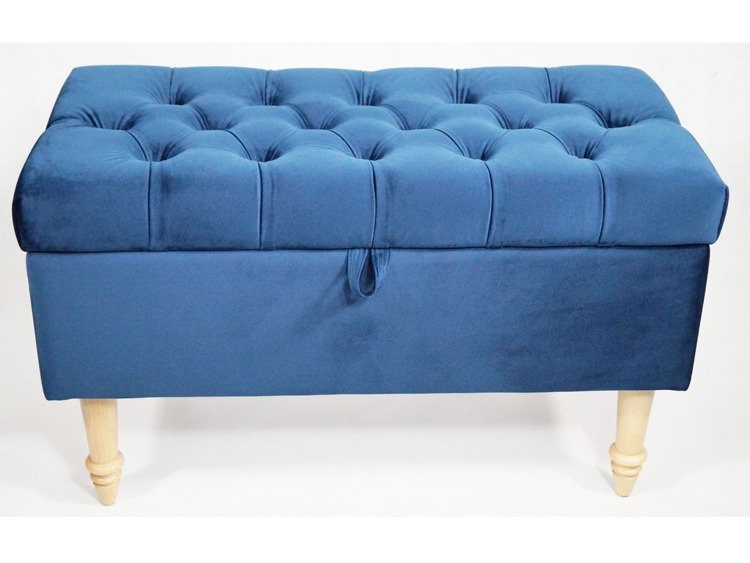 Niebieski, pikowany puf tapicerowany z drewnianymi nóżkami i schowkiem, na białym tle.
