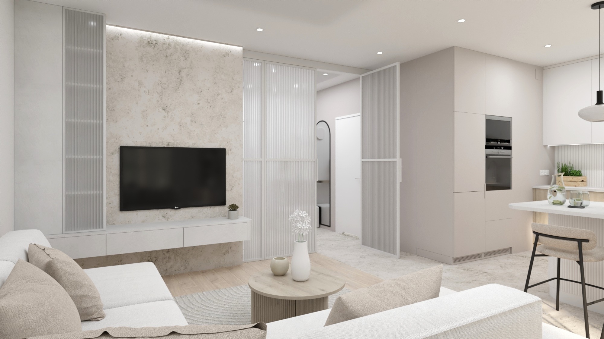 Jasne wnętrze salonu z aneksem kuchennym w minimalistycznym stylu. Na pierwszym planie sofa z beżowymi poduszkami, okrągły stolik kawowy i telewizor na ścianie o fakturze betonu. W tle widoczne...