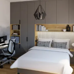 Nowoczesna sypialnia z biurkiem do pracy, szarą zabudową meblową, łóżkiem z białą pościelą i poduszkami w pepitkę, designerską lampą wiszącą i rośliną w doniczce na parapecie.