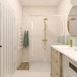 Jasna łazienka z terazzo, złota armatura, okrągłe lustro z podświetleniem LED i pralką w zabudowie pod umywalką.