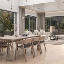 Whitehill Architecture Piotr Domanowski - Jasne wnętrze domu z drewnianą podłogą i stołem jadalnym, widok na schody i kominek. Projekt aranżacji w Białymstoku, z dużymi oknami i naturalnym światłem.