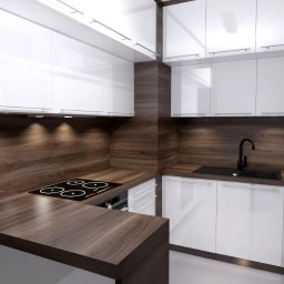 Amable - Nowoczesna kuchnia z białymi szafkami i drewnianym blatem, oświetlenie punktowe pod szafkami, kwiaty w wazonie. Minimalistyczny design z widocznymi detalami wykończenia.