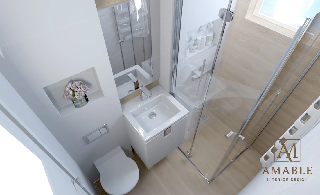 Wnętrze nowoczesnej łazienki z kabiną prysznicową, umywalką i toaletą. Minimalistyczny design, jasne kolory, kwiaty w niszy. Widok z góry.