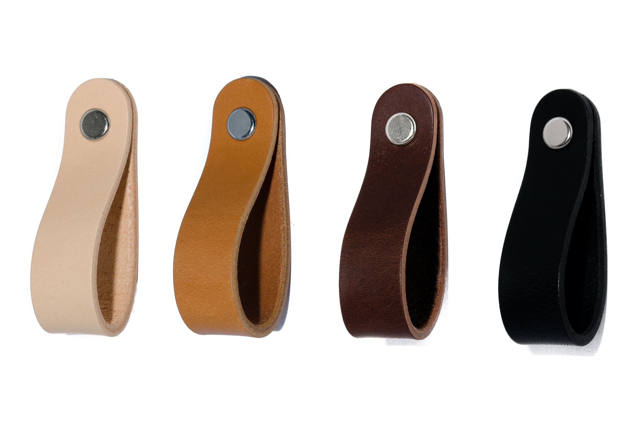 Cztery skórzane uchwyty meblowe w różnych kolorach (beżowy, brązowy, ciemnobrązowy i czarny) przymocowane metalowymi nitami, na białym tle.