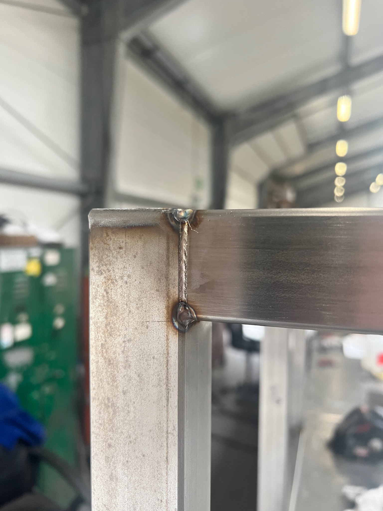 Spoina narożna ramy z profili metalowych, widoczne ślady po spawaniu, tło warsztatowe.