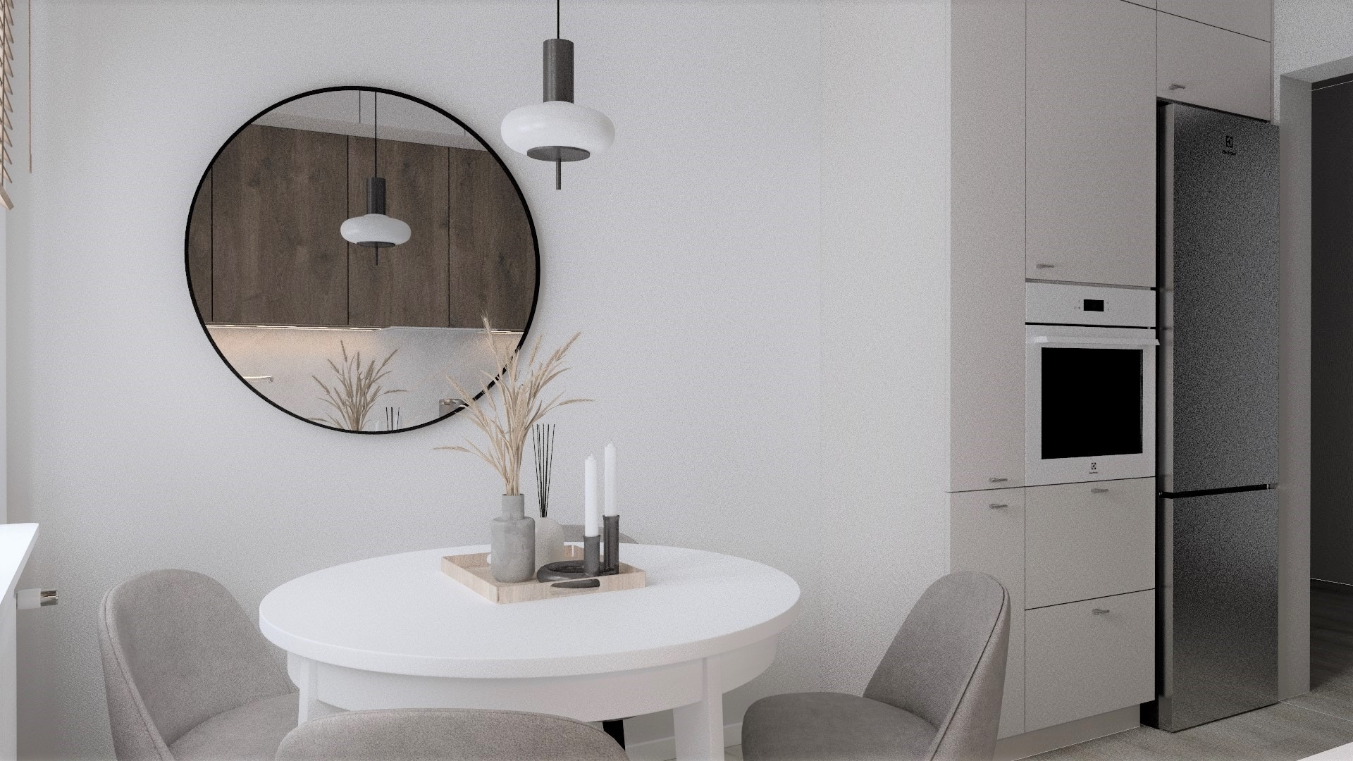 Jasne wnętrze kuchni z okrągłym lustrem, białym stołem i szarymi krzesłami, widok na zabudowę kuchenną z piekarnikiem i lodówką.