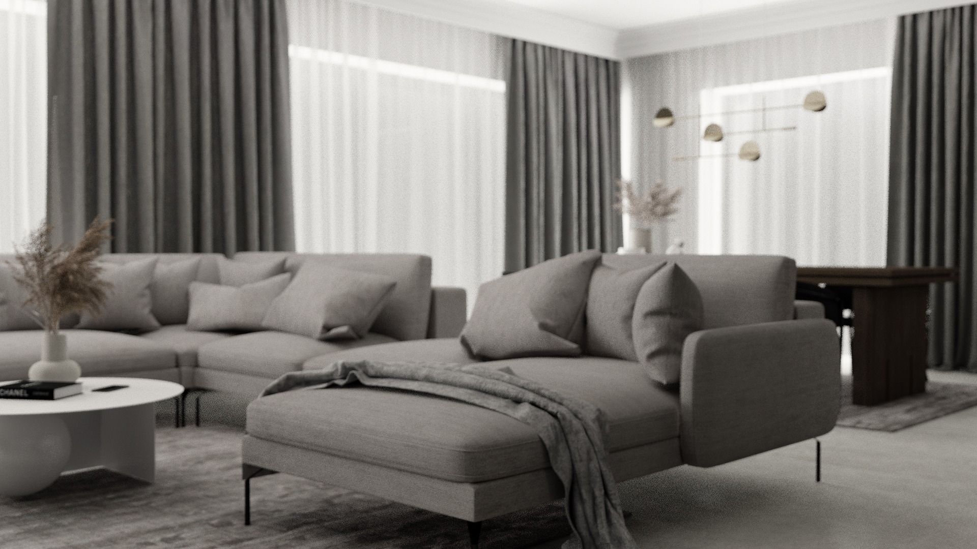 Szary narożnik z szezlongiem, pledem i okrągłym stolikiem kawowym na tle zasłon i nowoczesnej lampy wiszącej.