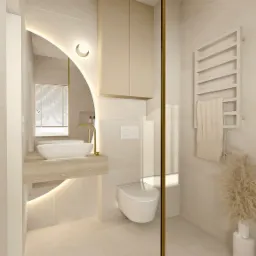Jasna łazienka z owalnym lustrem podświetlanym LED, białą umywalką nablatową na blacie imitującym marmur, wiszącą szafką i toaletą, grzejnikiem drabinkowym z ręcznikiem oraz dekoracyjną trawą...