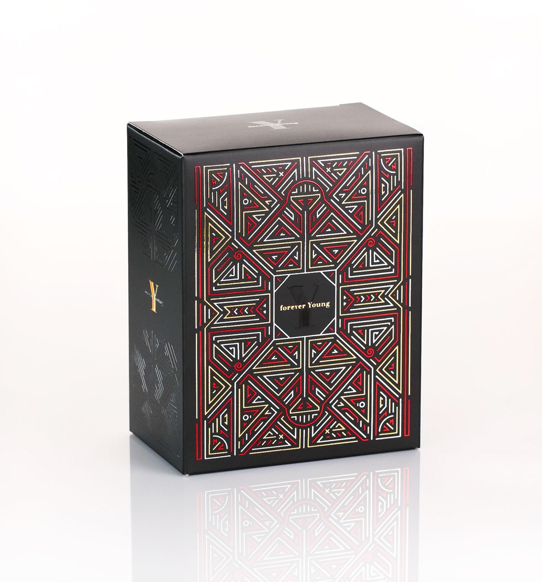 Eleganckie, czarne opakowanie kartonowe z geometrycznym wzorem w kolorach czerwonym, złotym i białym. Widoczny napis 'forever Young'.