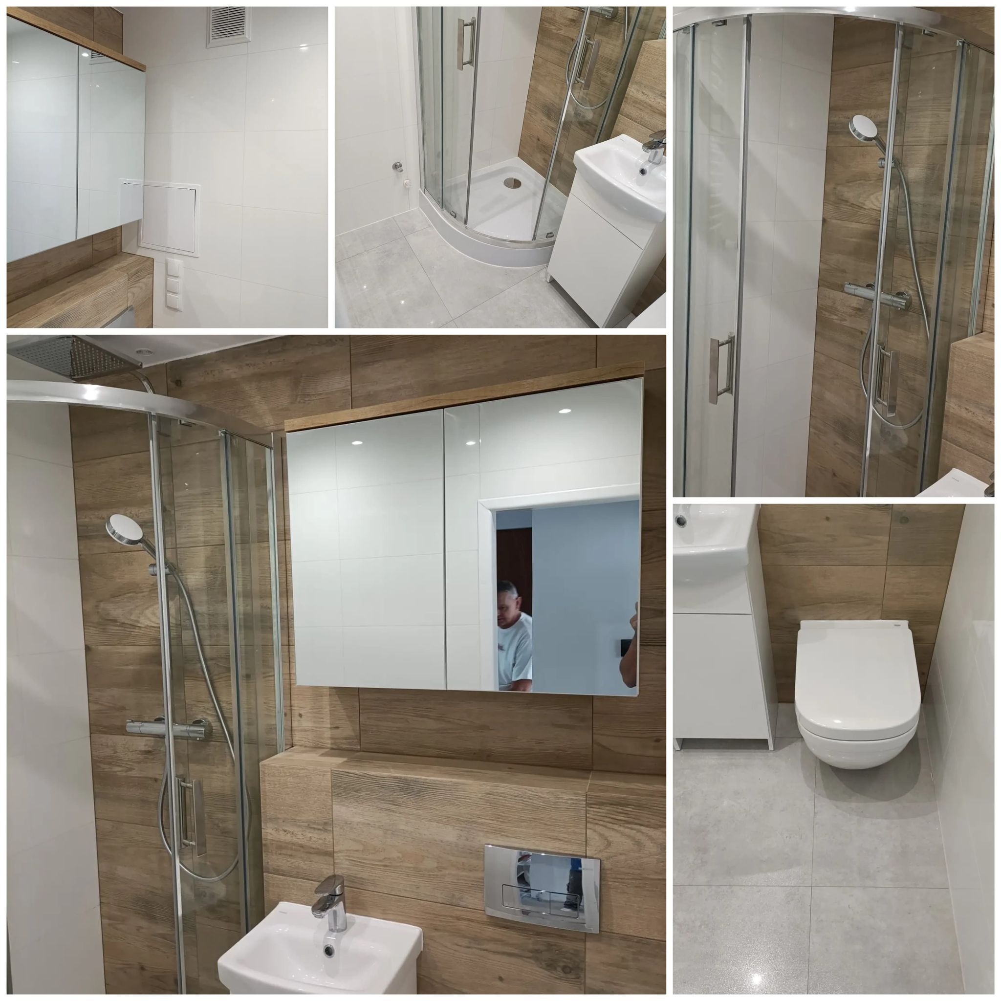 Wyremontowana łazienka z kabiną prysznicową, umywalką z szafką i podwieszaną toaletą, wykończona płytkami imitującymi drewno i białymi płytkami, widoczne odbicie osoby w lustrze.