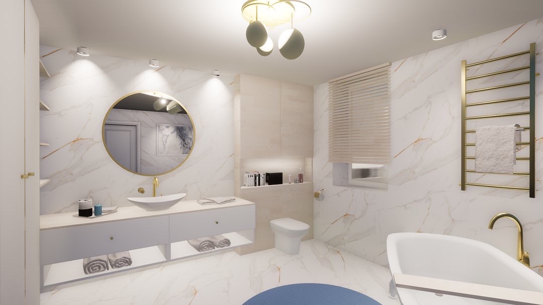 Elegancka, marmurowa łazienka w Tłuszczu z okrągłym lustrem w złotej ramie, designerską lampą sufitową i grzejnikiem drabinkowym w kolorze złota.