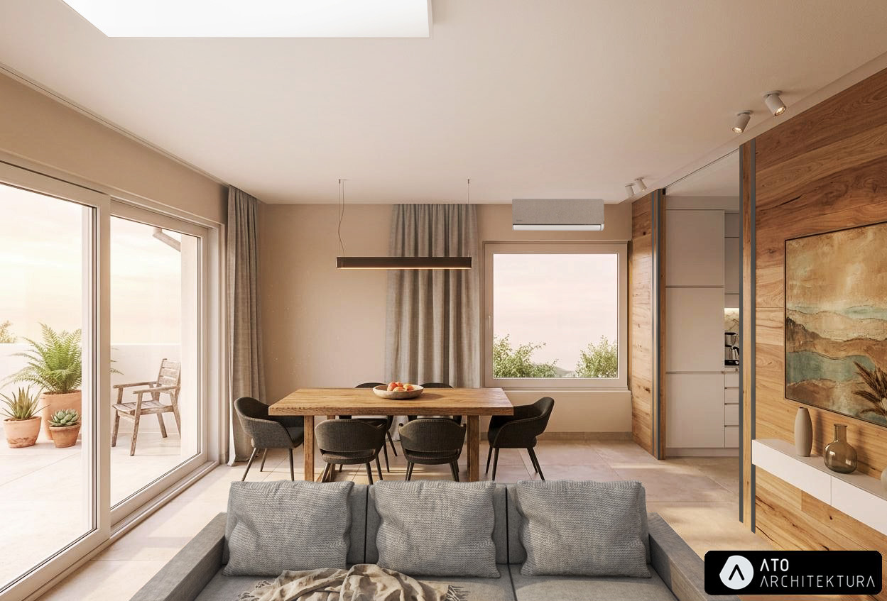 Jasne wnętrze z drewnianym stołem i szarą sofą. Widok na balkon z roślinami. Minimalistyczny design, ciepłe oświetlenie, drewniane akcenty. Nowoczesna aranżacja.