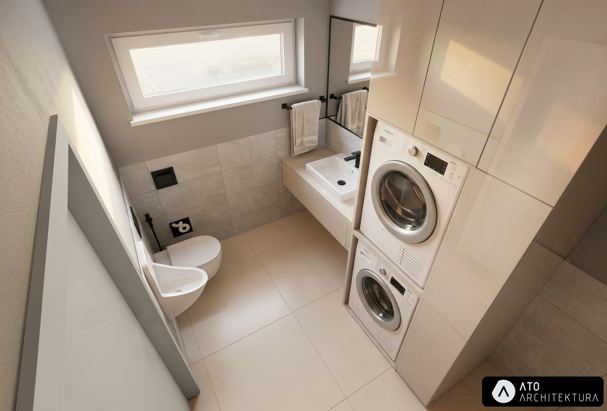 Jasna łazienka z pralką i suszarką w zabudowie, umywalką, toaletą i oknem. Minimalistyczny design z szarymi płytkami i białymi meblami. Widok z góry.